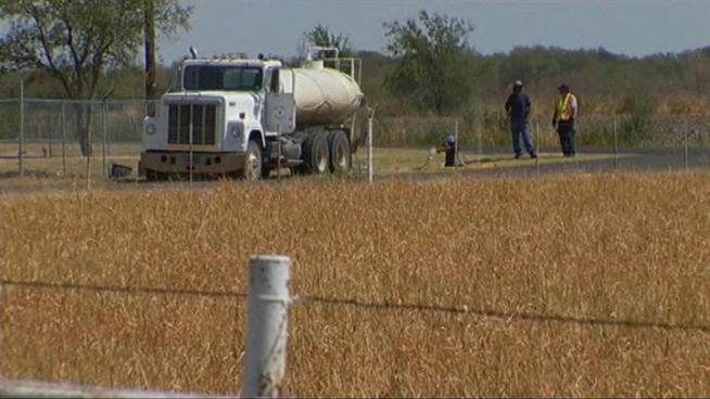 A grass fire sparked by a piece from a piece of mowing equipment is now mostly contained.
