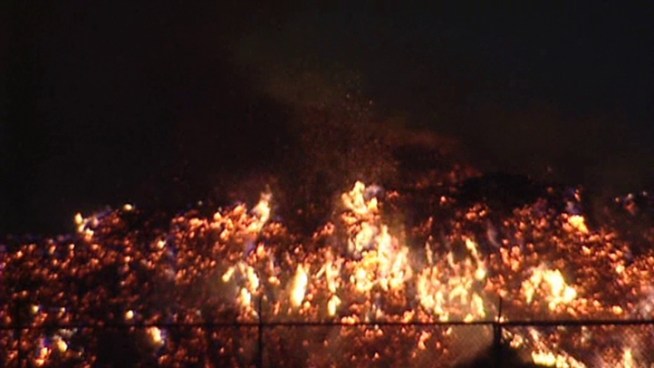 A fire at a mulch recycling facility continues to burn Thursday.
