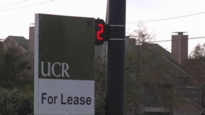One Garland intersection may be putting pedestrians in danger as a realtor's sign blocks the crossing signal.
