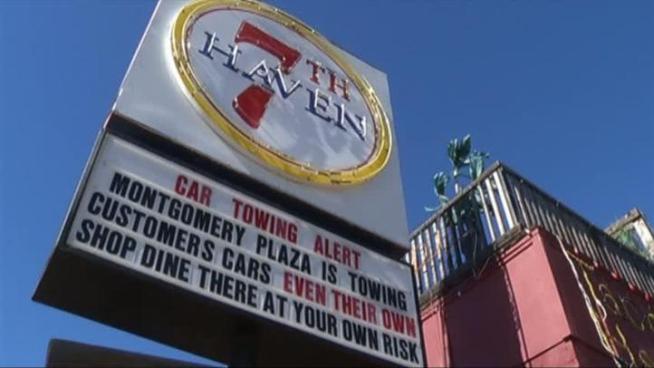 Towing signs on West Seventh Street have been displayed for nearly a year, but recent enforcement may affect business.