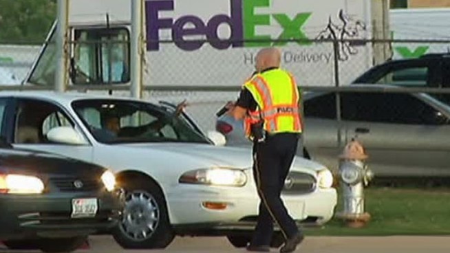 Police working a fatal crash on Regal Row and state Highway 183 had to draw their weapons when a woman ran up to them begging for help.