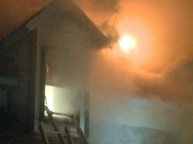 The Quinlan Fire Department had a tough time battling a house fire in the 11400 block of Highway 34 Tuesday night. Ammunition inside the home exploded for about 30 minutes.
