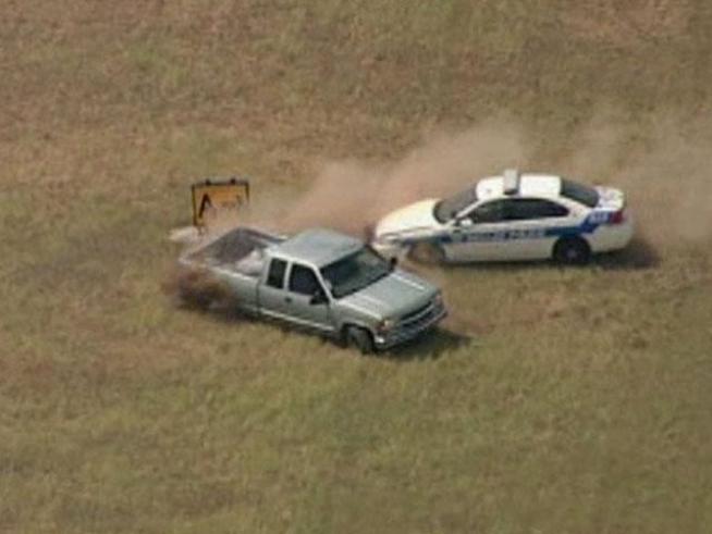 A suspected carjacker led police on an hour-long chase Thursday before crashing through a locked chain-link fence and driving across runways at <a title=