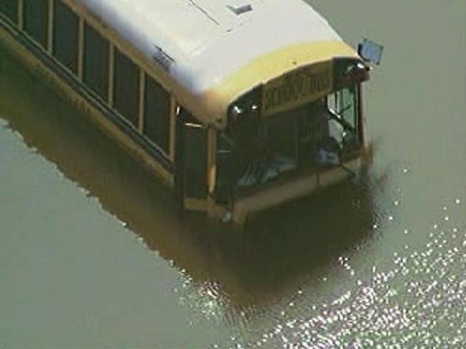 A school bus loaded with swimmers from a high school swim team went off the road and plunged into a small pond Monday morning.
