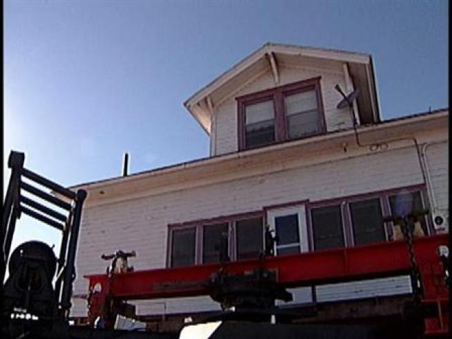 Crews moved the historic Coyle house to make way for the Bush Turnpike expansion project.