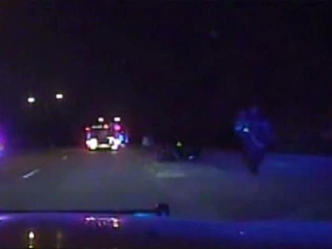 Two Dallas police officers rescued a family of four when they noticed a burning home while on patrol.