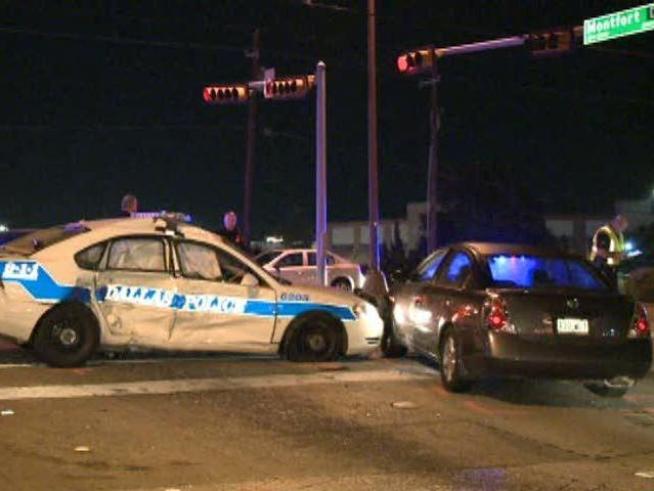 Woman not injured; police officer expected to be OK after crash.