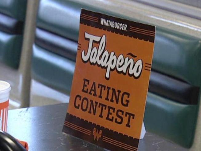 Firefighters, police complete in jalapeño-eating contest for charity.