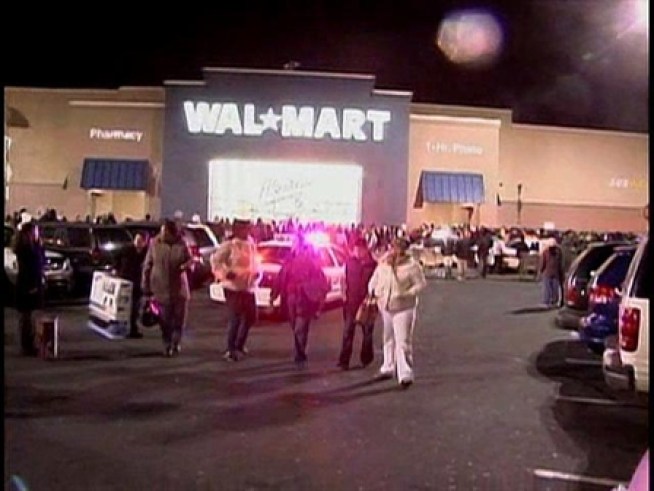 Police are called to the scene for medical emergencies as anxious shoppers wait on line at the mall.