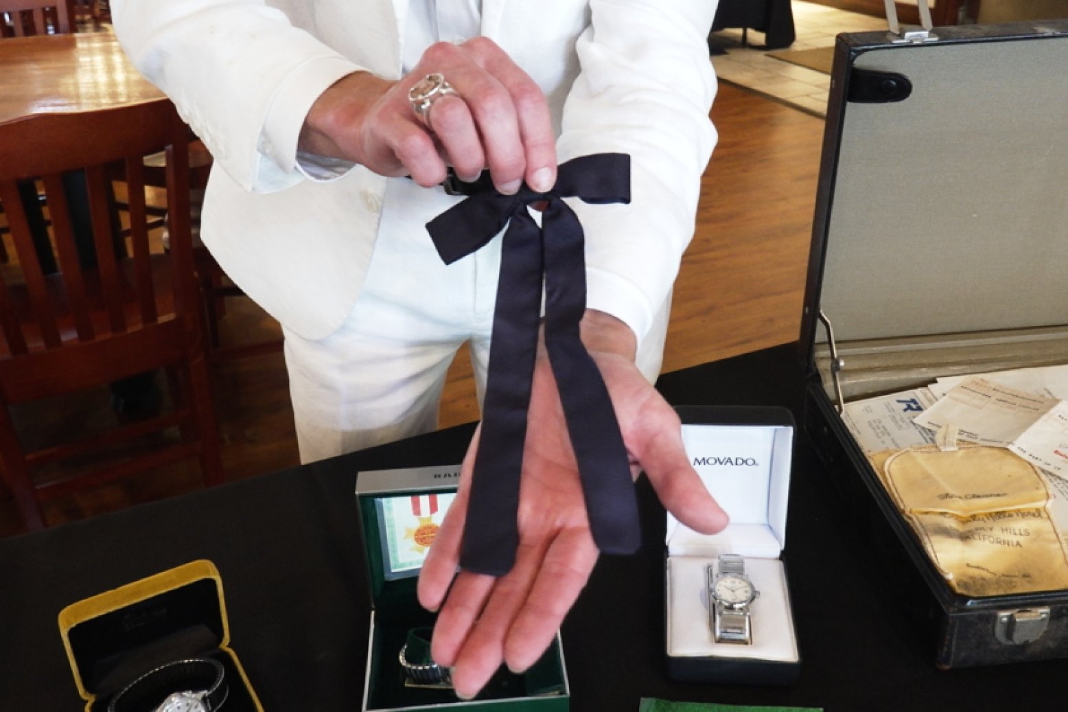 Auctioneer Jonathan Klunk shows a black bow tie worn by KFC founder