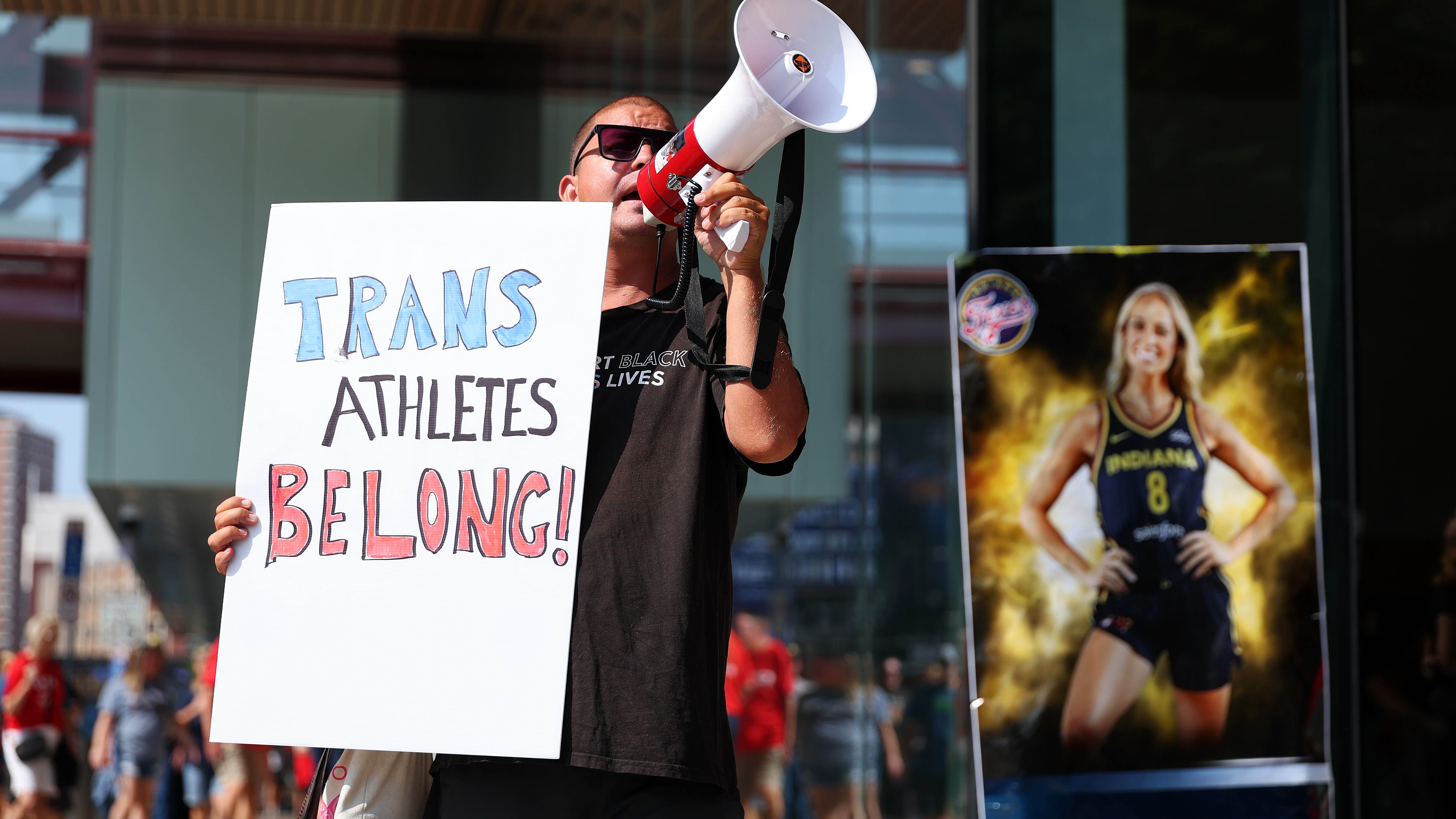 A demonstrator protests prior to the start of the WNBA game