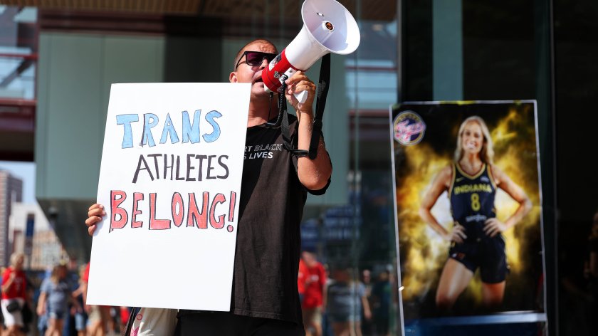A demonstrator protests prior to the start of the WNBA game