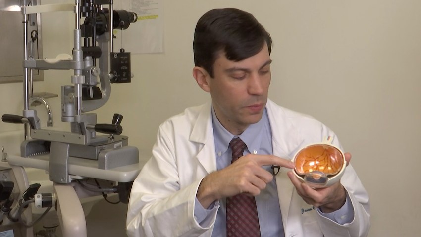 Dr. Jason Comander, inherited retinal disorder specialist at Massachusetts Eye and Ear Infirmary in Boston points to a model of an eye during an interview on Jan. 8, 2020. Comander's hospital plans to enroll patients in a gene editing treatment for blindness study. He said it marks “a new era in medicine” using a technology that “makes editing DNA much easier and much more effective.”