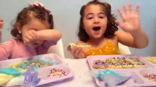 In this May 23, 2020, image from video, Liyana Mujovic, 2, her sister Suhaila, 5, and a group of friends decorate cookies for Eid al-Fitr over Zoom as they celebrate the end of a month-long fast, marking the end of Ramadan.