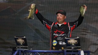 Previous Bassmaster holding up a bass.