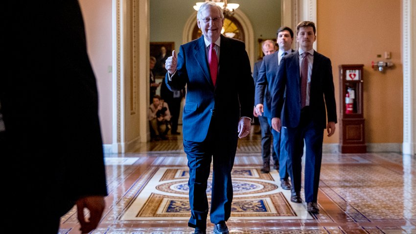 Senate Majority Leader Mitch McConnell of Ky. gives a thumbs up as he leaves the Senate chamber on Capitol Hill in Washington, March 25, 2020, after announcing a deal has been reached on a coronavirus bill.