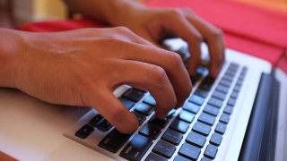 Photo of hands typing on a computer