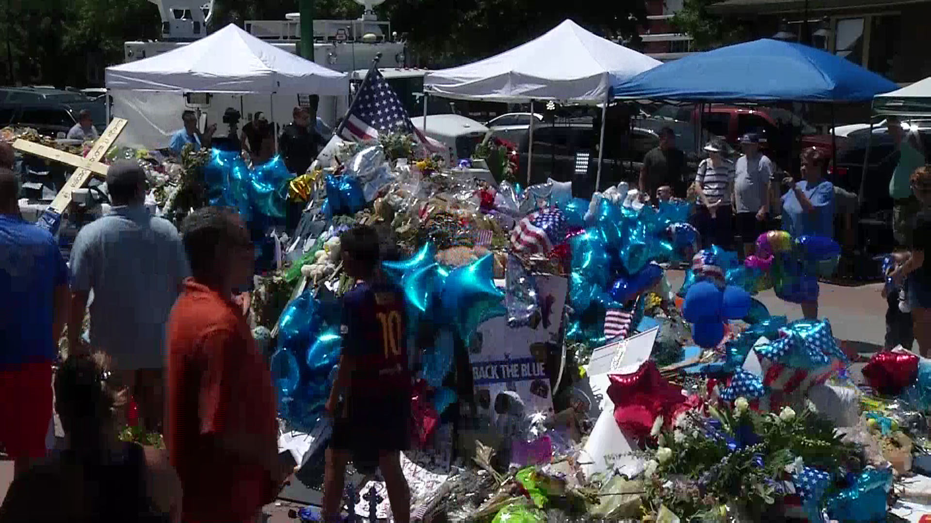 A memorial in front of the Dallas Police Headquarters is growing by the hour.