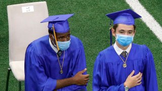 Jesuit College Preparatory School of Dallas graduate Emmitt 'EJ' Smith IV takes a knee during the national anthem at AT&T Stadium in Arlington, Texas, Friday, June 5, 2020. Because of the COVID-19 pandemic, the Dallas Cowboys hosted commencement ceremonies for local schools, including the Arlington ISD high schools. Over 1,100 people were in attendance, to see the 255 graduates get their diplomas.