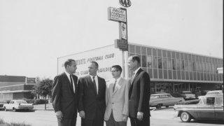 A photo of the Cowboys initial leadership group, pictured in front of the team's first administrative offices on North Central Expressway.