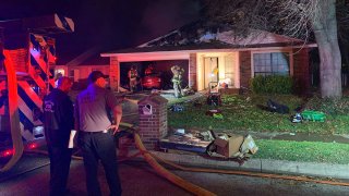 A woman rescued from a house fire in Fort Worth Monday evening was rushed to the hospital with critical burn injuries, firefighters said.