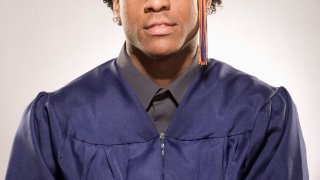 Portrait of a male high school graduate wearing cap and gown