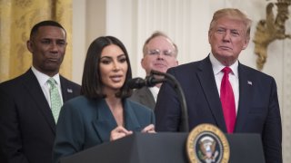 U.S. President Donald Trump, right, listens as reality star and activist Kim Kardashian West speaks about a second chance hiring and re-entry initiative at an event in the East Room of the White House in Washington, D.C., U.S., on Thursday June 13, 2019. Kardashian West took a star turn at the White House on Thursday to promote efforts to help those leaving prison get jobs and stay on track.