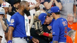 Albert Almora Jr. #5 of the Chicago Cubs, center, is comforted by Jason Heyward #22 and Javier Baez #9 after checking on a young child that was struck by a hard foul ball off his bat in the fourth inning against the Houston Astros at Minute Maid Park on May 29, 2019 in Houston, Texas.