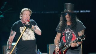 Axl Rose sings next to guitarist Slash