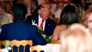 President Donald Trump and First Lady Melania Trump attend a Christmas Eve dinner with his family at Mar-A-Lago in Palm Beach, Florida, on Dec. 24, 2019.