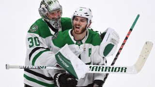 Dallas Stars goalie Ben Bishop (30) puts his arms around center Tyler Seguin (91) after the Stars defeated the Anaheim Ducks 3 to 0 in a game played on January 9, 2020 at the Honda Center in Anaheim, CA.