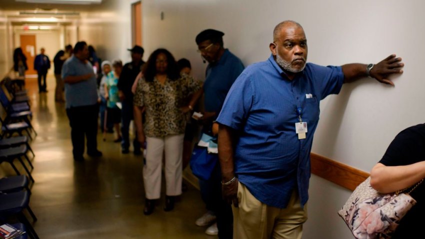 Voters wait in line to cast their ballots during the Democratic presidential primary in Houston, Texas on Super Tuesday, March 3, 2020. - Fourteen states and American Samoa are holding presidential primary elections, with over 1400 delegates at stake. Americans vote Tuesday in primaries that play a major role in who will challenge Donald Trump for the presidency, a day after key endorsements dramatically boosted Joe Biden's hopes against surging leftist Bernie Sanders. The backing of Biden by three of his ex-rivals marked an unprecedented turn in a fractured, often bitter campaign.
