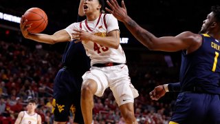 Rasir Bolton of the Iowa State Cyclones lays up a shot as Derek Culver of the West Virginia Mountaineers blocks in the first half of the play at Hilton Coliseum on March 3, 2020 in Ames, Iowa.