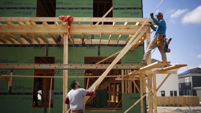 Contractors construct a wood deck while working on a home under construction in the Norton Commons subdivision in Louisville, Kentucky.