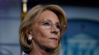 Secretary of Education Betsy DeVos listens as U.S. President Donald Trump speaks during a briefing on the coronavirus pandemic in the press briefing room of the White House on March 26, 2020 in Washington, D.C.