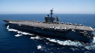 In this handout released by the U.S. Navy, The aircraft carrier USS Theodore Roosevelt (CVN 71) transits the Pacific Ocean.