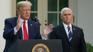 President Donald Trump speaks as Vice President Mike Pence look on during a news conference on the novel coronavirus, COVID-19, in the Rose Garden of the White House in Washington, DC on April 27, 2020.