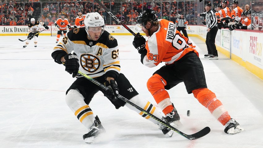 Brad Marchand of the Boston Bruins passes the puck between the legs of Jakub Voracek of the Philadelphia Flyers on March 10, 2020 at the Wells Fargo Center in Philadelphia.