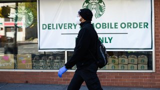 A person wears a protective face mask outside Starbucks in Kips Bay during the coronavirus pandemic on May 13, 2020 in New York City.