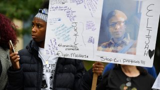 In this Oct. 1, 2019, file photo, Rashiaa Veal holds a sign featuring her cousin, Elijah McClain, at a news conference in front of the Aurora Municipal Center in Aurora, Colorado.