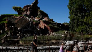 Guests walk in line to Splash Mountain at Walt Disney Co.'s Disneyland Park