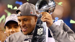 Outside linebacker and Super Bowl MVP Malcolm Smith #53 of the Seattle Seahawks holds the Vince Lombardi Trophy after winning Super Bowl XLVIII at MetLife Stadium on February 2, 2014 in East Rutherford, New Jersey