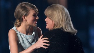 Honoree Taylor Swift accepts the 50th Anniversary Milestone Award for Youngest ACM Entertainer of the Year from her mother, Andrea Finlay, during the 50th Academy of Country Music Awards at AT&T Stadium on April 19, 2015, in Arlington, Texas.