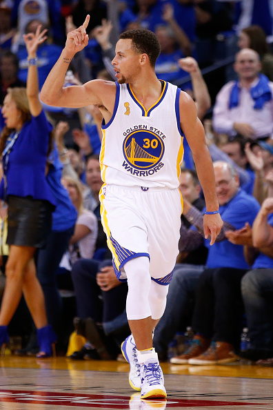 OAKLAND, CA - OCTOBER 27: Stephen Curry #30 of the Golden State Warriors celebrates after a three point basket against the New Orleans Pelicans during the NBA season opener at ORACLE Arena on October 27, 2015 in Oakland, California. NOTE TO USER: User expressly acknowledges and agrees that, by downloading and or using this photograph, User is consenting to the terms and conditions of the Getty Images License Agreement. (Photo by Ezra Shaw/Getty Images)