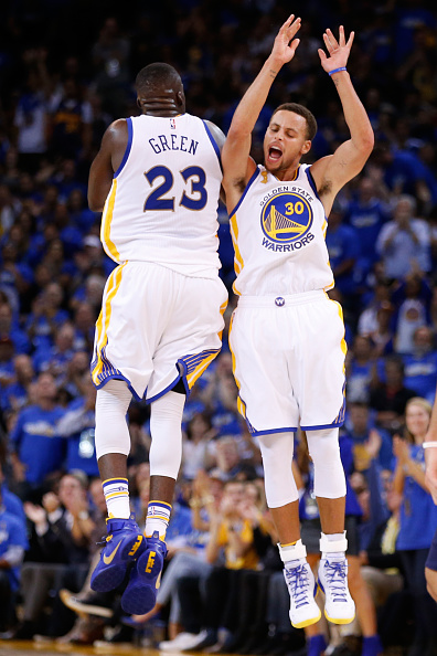 OAKLAND, CA - OCTOBER 27: Stephen Curry #30 of the Golden State Warriors celebrates with Draymond Green #23 after a three point basket against the New Orleans Pelicans during the NBA season opener at ORACLE Arena on October 27, 2015 in Oakland, California. NOTE TO USER: User expressly acknowledges and agrees that, by downloading and or using this photograph, User is consenting to the terms and conditions of the Getty Images License Agreement. (Photo by Ezra Shaw/Getty Images)