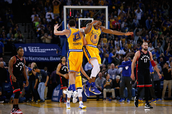 OAKLAND, CA - NOVEMBER 17: Andre Iguodala #9 and Klay Thompson #11 of the Golden State Warriors celebrate after Thompson threw and alley-oop dunk pass to Iguodala during their game against the Toronto Raptors at ORACLE Arena on November 17, 2015 in Oakland, California. NOTE TO USER: User expressly acknowledges and agrees that, by downloading and or using this photograph, User is consenting to the terms and conditions of the Getty Images License Agreement. (Photo by Ezra Shaw/Getty Images)
