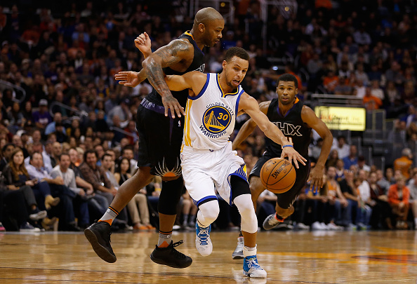 PHOENIX, AZ - NOVEMBER 27: Stephen Curry #30 of the Golden State Warriors is fouled as he drives past P.J. Tucker #17 of the Phoenix Suns during the first half of the NBA game at Talking Stick Resort Arena on November 27, 2015 in Phoenix, Arizona. NOTE TO USER: User expressly acknowledges and agrees that, by downloading and or using this photograph, User is consenting to the terms and conditions of the Getty Images License Agreement. (Photo by Christian Petersen/Getty Images)