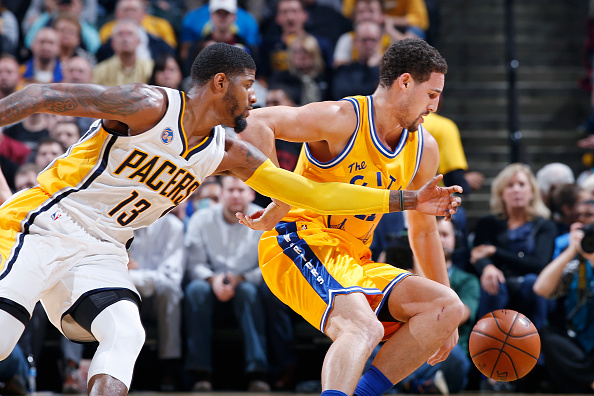 INDIANAPOLIS, IN - DECEMBER 8: Klay Thompson #11 of the Golden State Warriors goes for a loose ball against Paul George #13 of the Indiana Pacers in the first half of the game at Bankers Life Fieldhouse on December 8, 2015 in Indianapolis, Indiana. NOTE TO USER: User expressly acknowledges and agrees that, by downloading and or using the photograph, User is consenting to the terms and conditions of the Getty Images License Agreement. (Photo by Joe Robbins/Getty Images)
