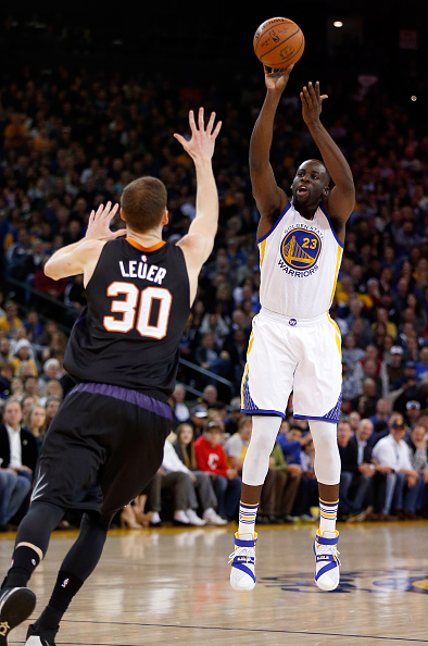 OAKLAND, CA - DECEMBER 16: Draymond Green #23 of the Golden State Warriors shoots over Jon Leuer #30 of the Phoenix Suns at ORACLE Arena on December 16, 2015 in Oakland, California. NOTE TO USER: User expressly acknowledges and agrees that, by downloading and or using this photograph, User is consenting to the terms and conditions of the Getty Images License Agreement. (Photo by Ezra Shaw/Getty Images)