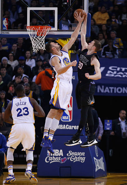 OAKLAND, CA - DECEMBER 16: Andrew Bogut #12 of the Golden State Warriors goes up to block a shot taken by Jon Leuer #30 of the Phoenix Suns at ORACLE Arena on December 16, 2015 in Oakland, California. NOTE TO USER: User expressly acknowledges and agrees that, by downloading and or using this photograph, User is consenting to the terms and conditions of the Getty Images License Agreement. (Photo by Ezra Shaw/Getty Images)